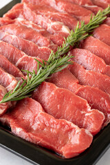 raw boneless veal steak on white wooden background. Close-up beef anricot meat