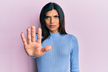 Young latin transsexual transgender woman wearing casual clothes doing stop sing with palm of the hand. warning expression with negative and serious gesture on the face.