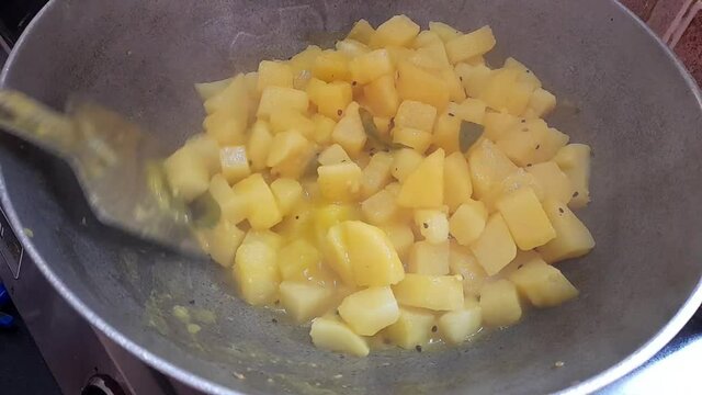 Making potato masala in a pan Indian style of cooking
