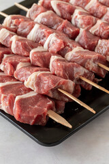 Raw Lamb skewers on a white wooden background. Meat background. Meat close-up