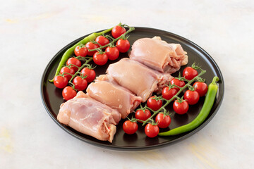 Raw boneless chicken thigh on a white wooden background. Chicken Meat background.