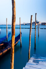 Gondolas and pier over Venice lagoon
