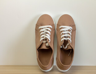 Comfortable beige sneakers for everyday wear on a light background.
