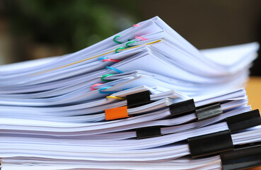 Closeup of a  pile of paper documents in office. 