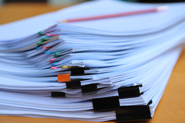 Closeup of a  pile of paper documents.