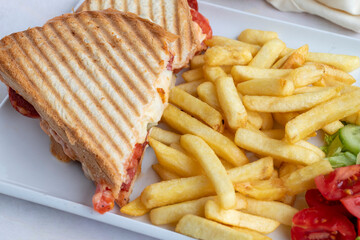 Tomato and cheese toast on a white wooden background. Local name ayvalık tostu