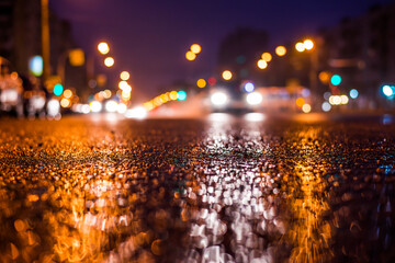 Rainy night in the big city, the car headlights shine through the mist. Close up view from the...