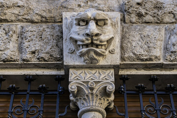 Architectural fragments of a Roman Traditional old house with barrels and sculptures in the old town of the city. Rome, Lazio, Italy, Europe.