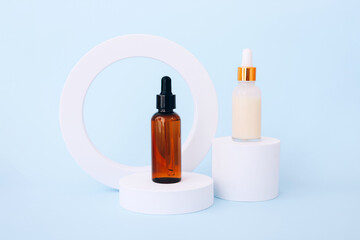 Trendy background with natural cosmetic skincare bottles on blue background. Product presentation.