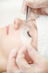 Obraz na płótnie Canvas Close up professional procedure of eyelash extension in the clinic