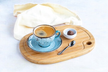 A cup of coffee on a white wooden background