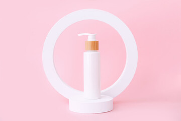 Cosmetic skin care products staying on the geometrical podiums. Product presentation on pink...