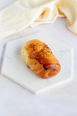 pastry with minced meat on a white wooden background. Local name kıymalı poğaça