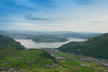 Naklejka premium Landscape view of the valley of Stans, with a lake in the background, shot in Stanserhorn, Nidwald, Switzerland