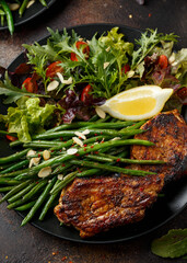 Grilled pork loin chops served with French green beans salad and beer