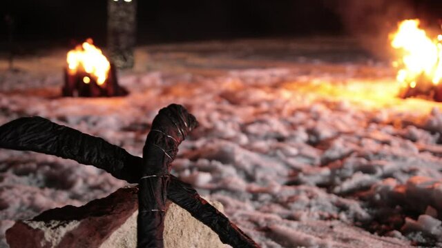 Crossed swords. Black weapons for combat lie on the snow in a crossed form. Ready to be set on fire, so that it burn and fights