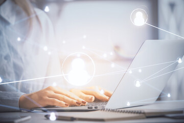 Double exposure of woman hands typing on computer and social network theme hologram drawing. People...
