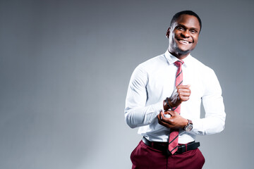 Happy african american businessman going to work buttoning sleeves on shirt smiling