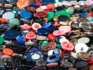 many various used buttons on surface closeup