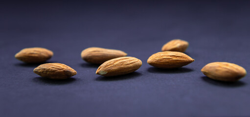 Almonds closeup isolated in blue backround.