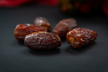 Sweet soft moist natural dates ioslated with a dark background.