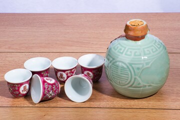 Fototapeta na wymiar Chinese Clay bottle with rice wine and shots glasses 