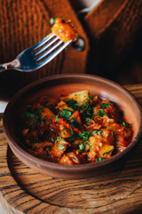 Ajapsandali on clay plate with fork in georgian restaurant