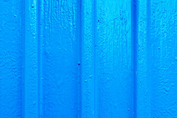 Blue metal wall with stiffening ribs. Close up view
