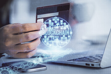 Multi exposure of woman on-line shopping holding a credit card and crypto theme drawing. Blockchain E-commerce concept.