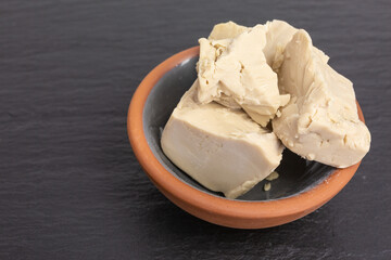 pieces of fresh baker's yeast in a bowl