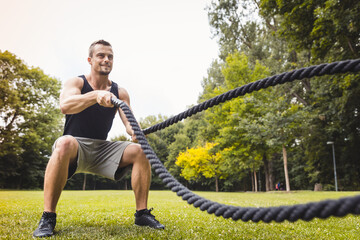 Man using battle rope during workout