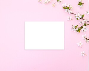 Horizontal blank card mockup on pink floral background for greeting card, invitation, letter, note paper, stationery design.