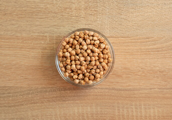 Bowl of raw grain chickpeas on a wooden table