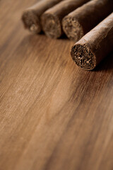 Fototapeta na wymiar Group of brown cuban cigars on wooden background