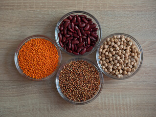Bowls of cereal grains: chickpeas, red lentils, red bean, sorghum grain
