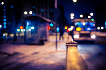 Winter night in the big city, the bus arrives to a stop for passengers. Close up view from the...