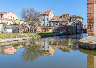 Fototapeta na wymiar Comacchio, Italy - often compared to Venice for the canals and the architecture, Comacchio displays one of the most characteristic old towns in Emilia Romagna
