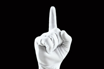 Brush, Hand in a white glove isolated on a black background, shows the index finger. Concept human gesture direction, idea, attention, one.