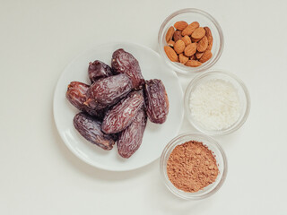 Top view set of various ingredients for vegan sweets with coconut  arranged on white table