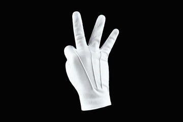Human hand, hand in white glove isolated on black background, shows three fingers gesture. Human gesture concept.
