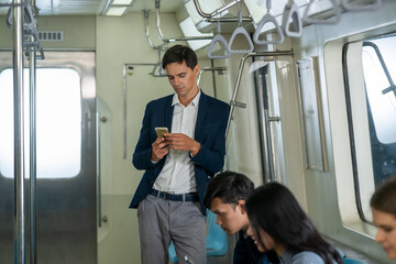 Business People passenger using smartphone in the subway while traveling to work during rush hours.