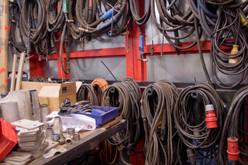 electric cables and welding cables hang on the wall