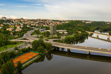 Aerial view of the railway bridge and the bridge for cars in Prague, which connects Prague 7 Holesovice and Prague 8. Beautiful view of the city in a summer day. - obrazy, fototapety, plakaty