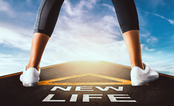 Woman standing on New life road leading to a blue sky for New begining concept.
