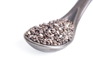 A heaping spoon of chia seeds isolated on white