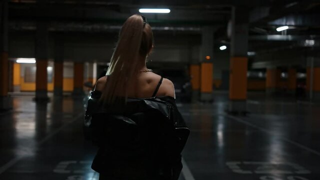 Portrait of a sexy young girl in the parking lot. Car