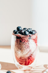 Healthy chia pudding in a glass with fresh blueberries