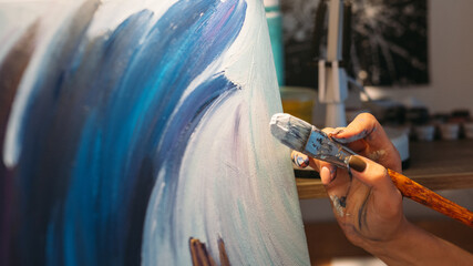 Visual art. Painting hobby. Talent imagination. Female painter hand creating blue white...
