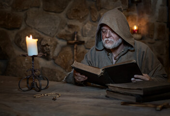 Old studying monk in the Middle Ages - obrazy, fototapety, plakaty