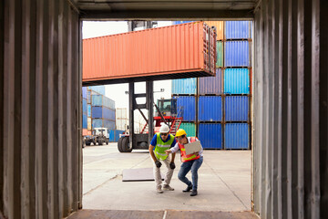 Logistics engineer control at the port. Foreman and staff are opening containers to check stock.